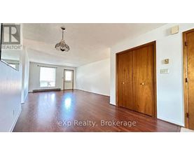 A room with a wooden floor and a ceiling light fixture.