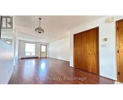 A room with a wooden floor and a ceiling light fixture.