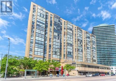 A tall building with many windows is the main focus of the image.