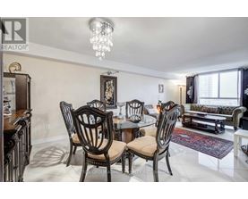 A dining room with a table set for four.
