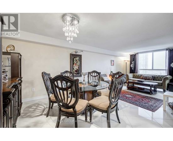 A dining room with a table set for four.