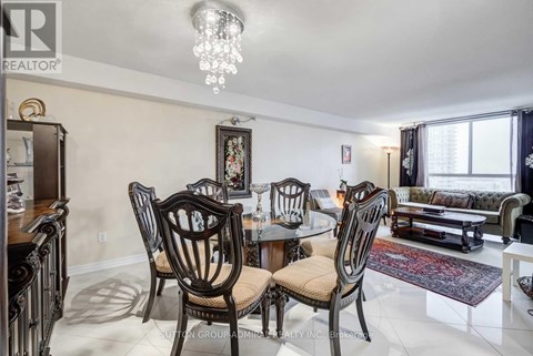A dining room with a table set for four.