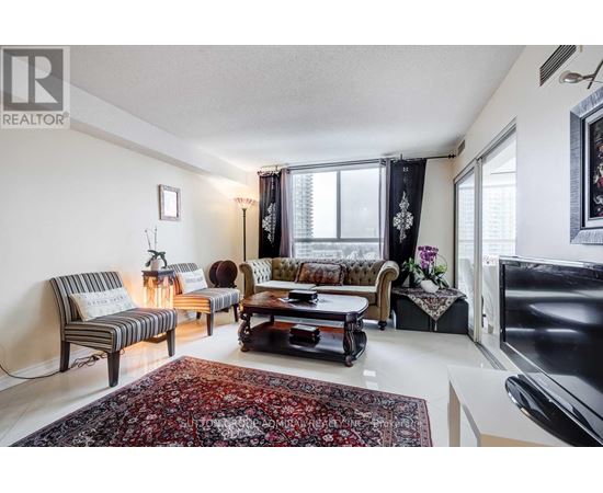 A living room with a rug and a couch.