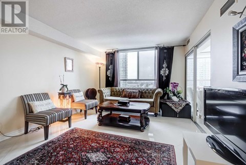 A living room with a rug and a couch.