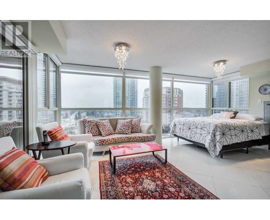 A bedroom with a large bed and a view of the city.