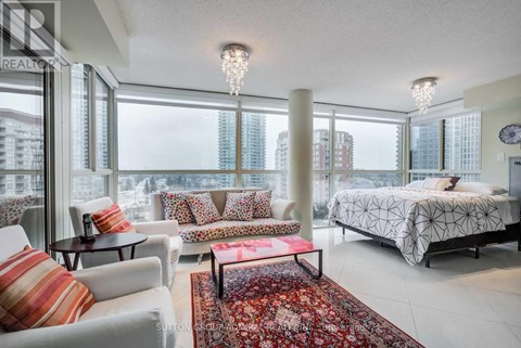 A bedroom with a large bed and a view of the city.