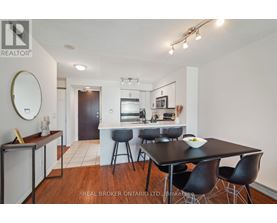 A dining room with a table set for four.