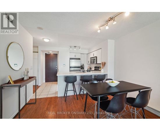 A dining room with a table set for four.