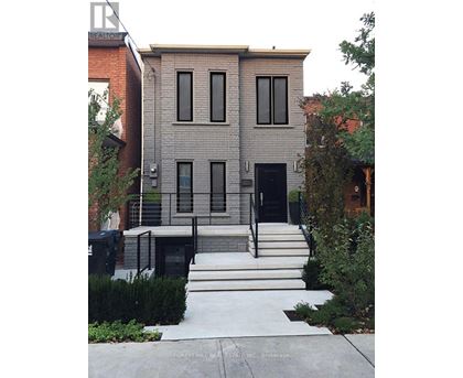 A modern house with a black front door and windows.