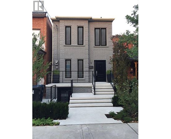 A modern house with a black front door and windows.