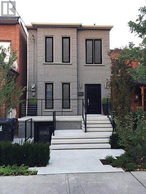 A modern house with a black front door and windows.