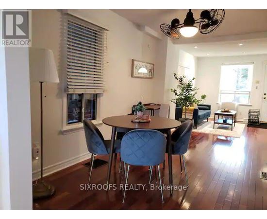 A dining room with a table and chairs.