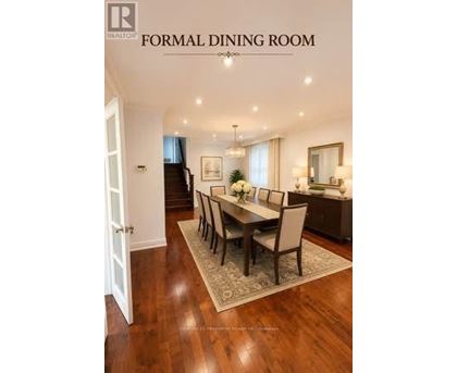 A formal dining room with a wooden table and chairs.