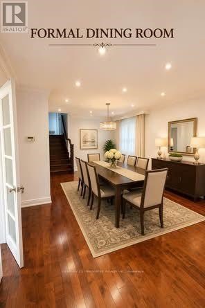 A formal dining room with a wooden table and chairs.