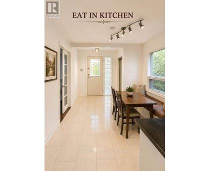 A kitchen with a table and chairs in the middle of the room.