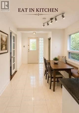 A kitchen with a table and chairs in the middle of the room.
