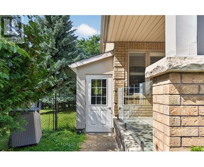 A small white door is on the side of a house.