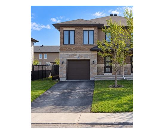 A house with a brown garage door and a black fence.