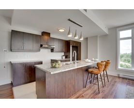 A modern kitchen with a dining table and chairs.