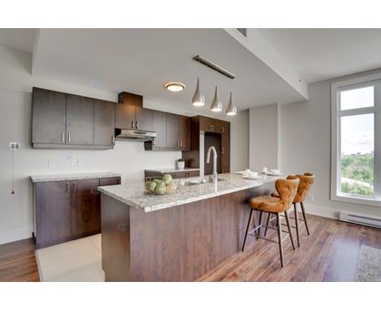A modern kitchen with a dining table and chairs.