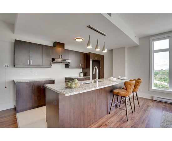 A modern kitchen with a dining table and chairs.