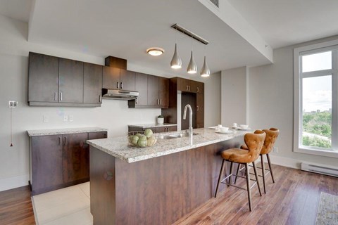 A modern kitchen with a dining table and chairs.
