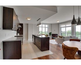 A modern living room with a dining table and chairs.