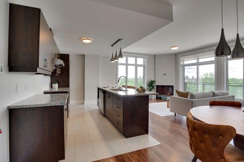 A modern living room with a dining table and chairs.