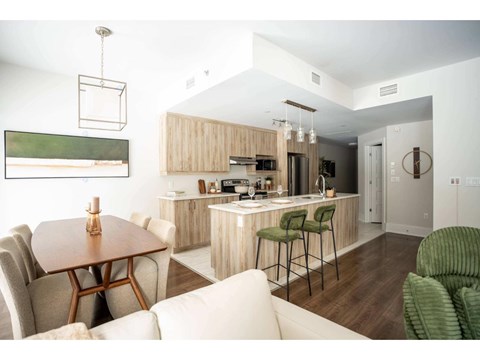 A modern kitchen with a dining table and chairs.