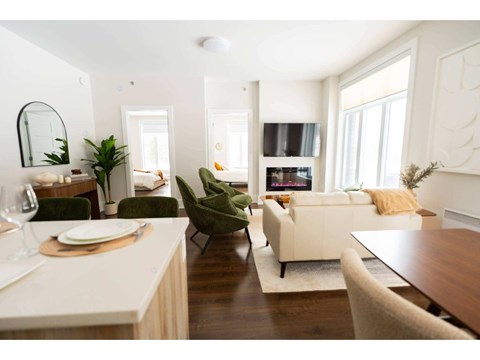 A modern living room with a dining table and chairs.