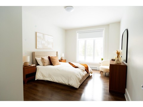 A bedroom with a large bed and a window.