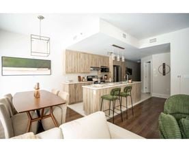A modern kitchen with a dining table and chairs.