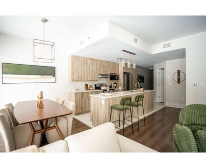 A modern kitchen with a dining table and chairs.