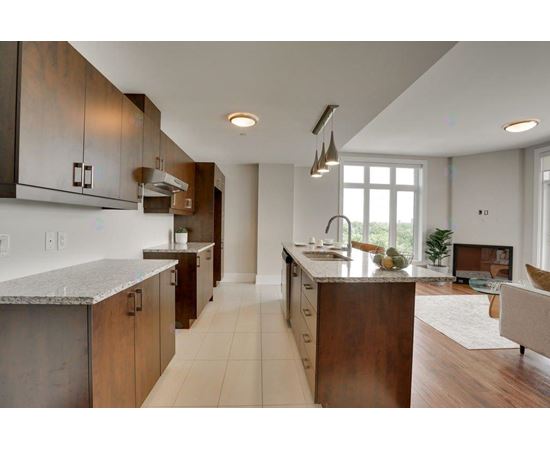 A modern kitchen with a dining table and chairs.