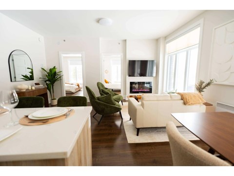 A modern living room with a dining table and chairs.