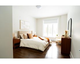 A bedroom with a large bed and a window.