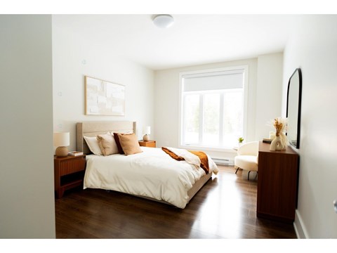 A bedroom with a large bed and a window.