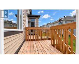 A wooden deck with a railing and a view of the sky.