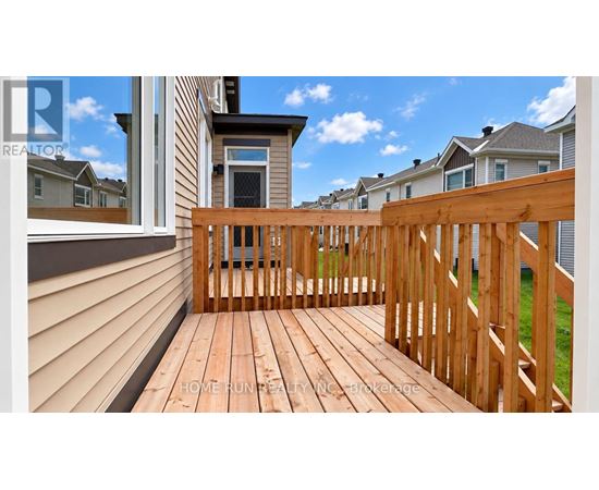 A wooden deck with a railing and a view of the sky.