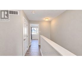 A hallway with a door on the left and a window on the right.