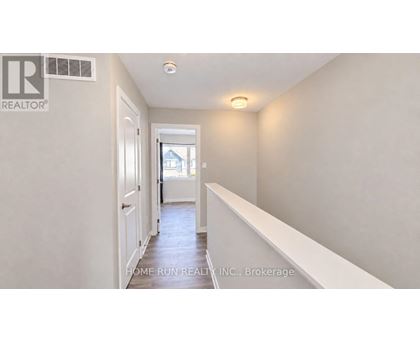 A hallway with a door on the left and a window on the right.