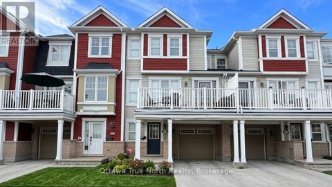 A row of townhouses with balconies and front doors.