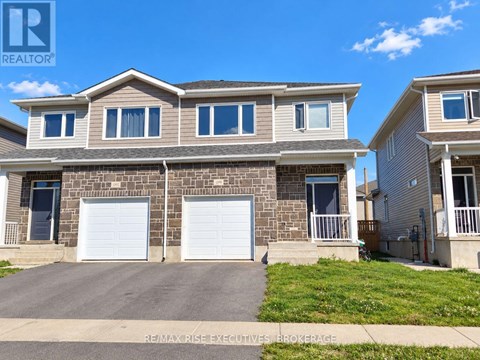 A two-story house with a garage is for sale.