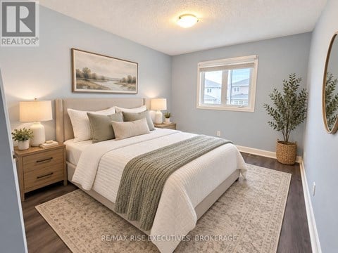 A bedroom with a large bed and a painting on the wall.