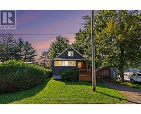 A house with a sign that says REALTOR in the upper left corner.