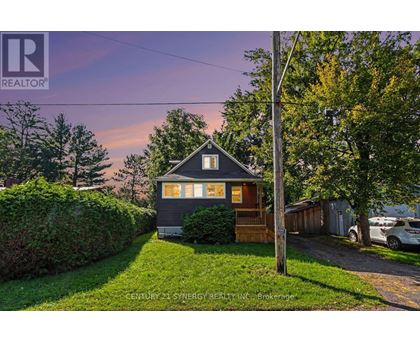 A house with a sign that says REALTOR in the upper left corner.