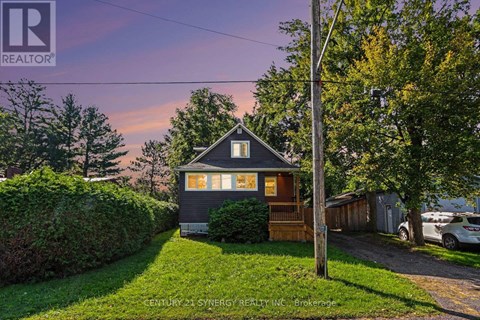 A house with a sign that says REALTOR in the upper left corner.