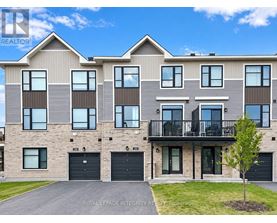A modern two-story residential building with a balcony on the second floor.