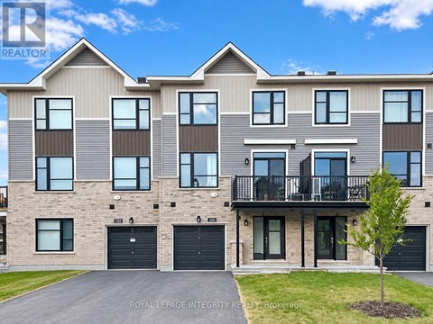 A modern two-story residential building with a balcony on the second floor.