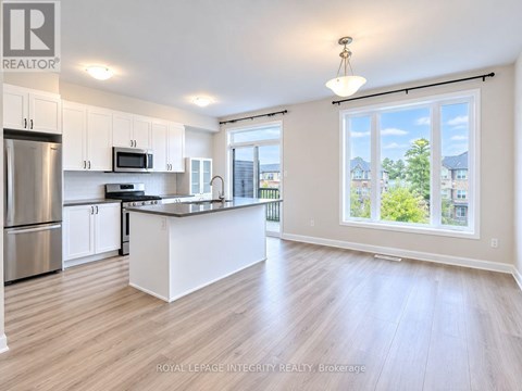 A spacious kitchen with white cabinets and a large island.